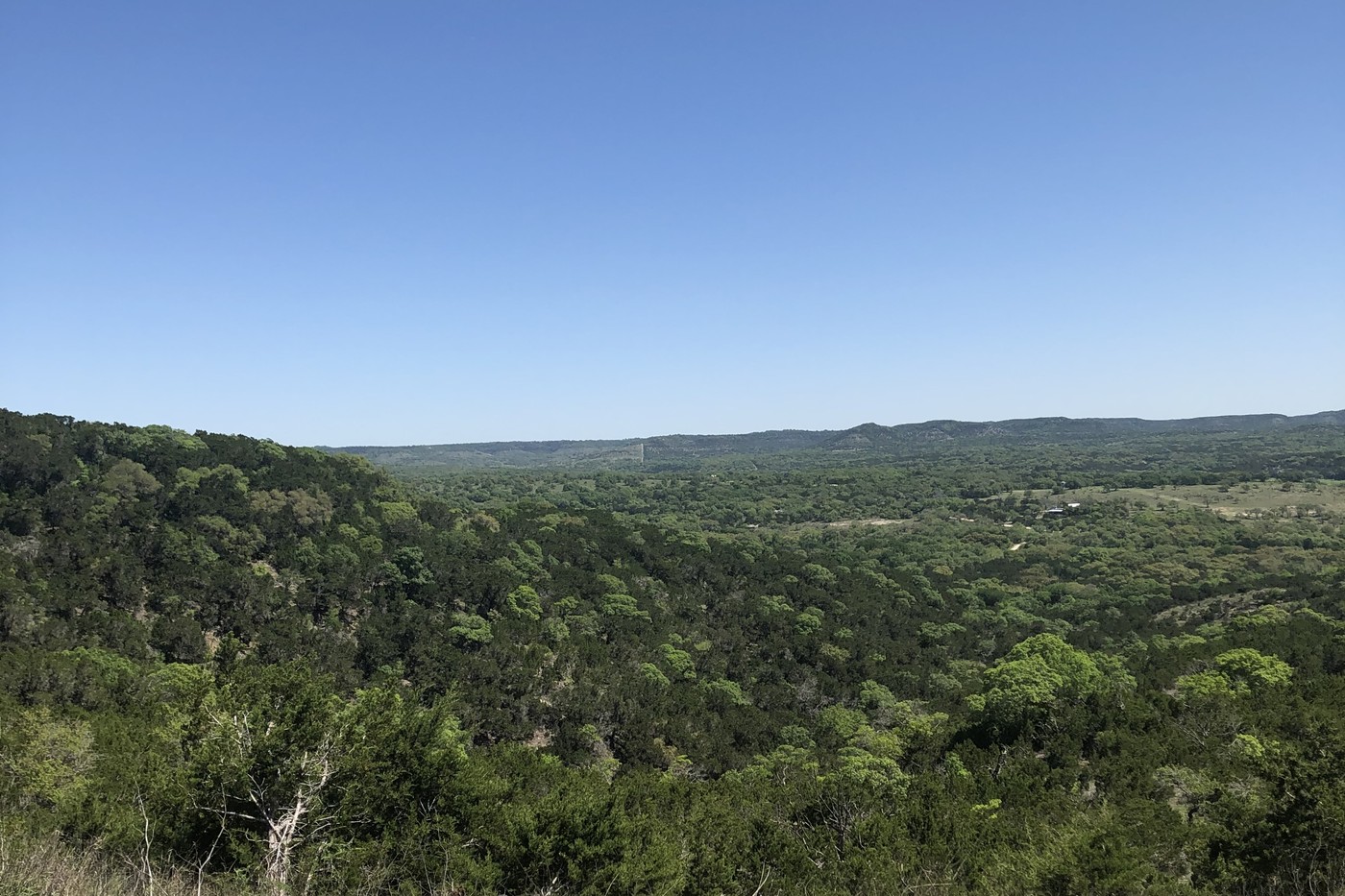 A sweeping view of the Texas Hill Country valley and hills near San Antonio