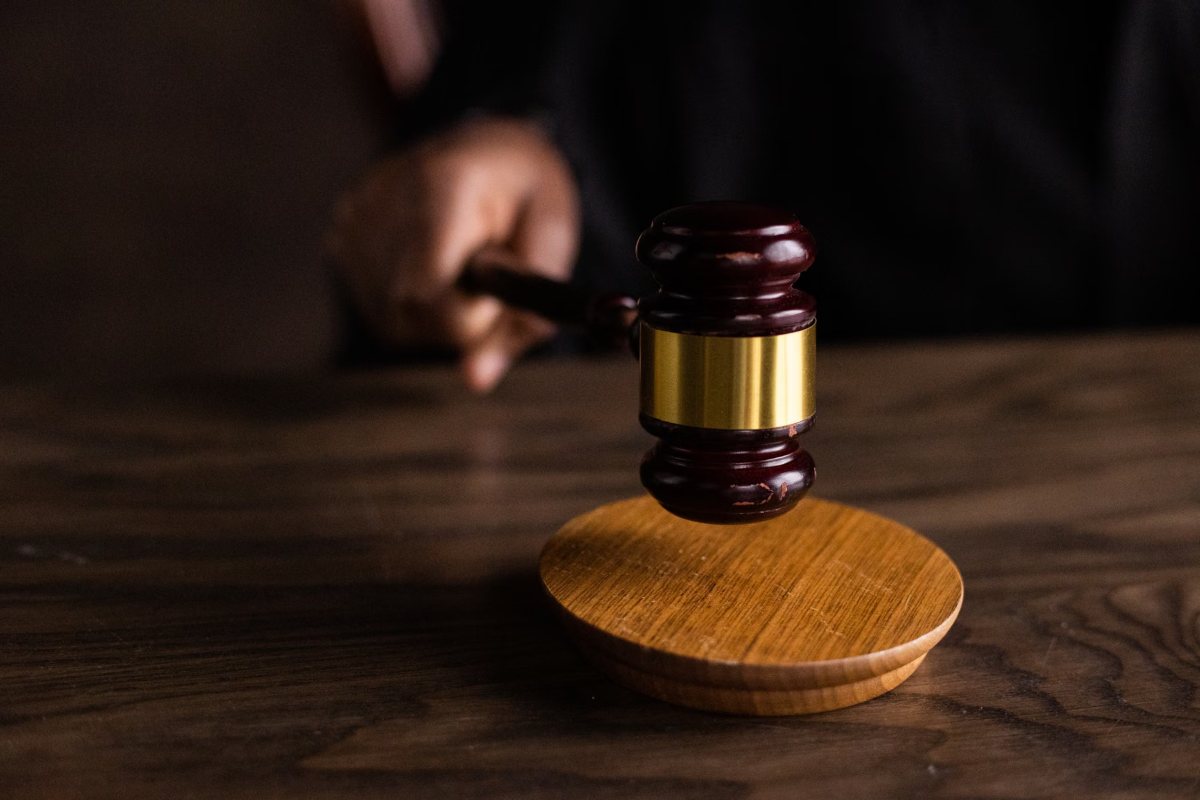 Judge's gavel poised above the sound block in a courtroom