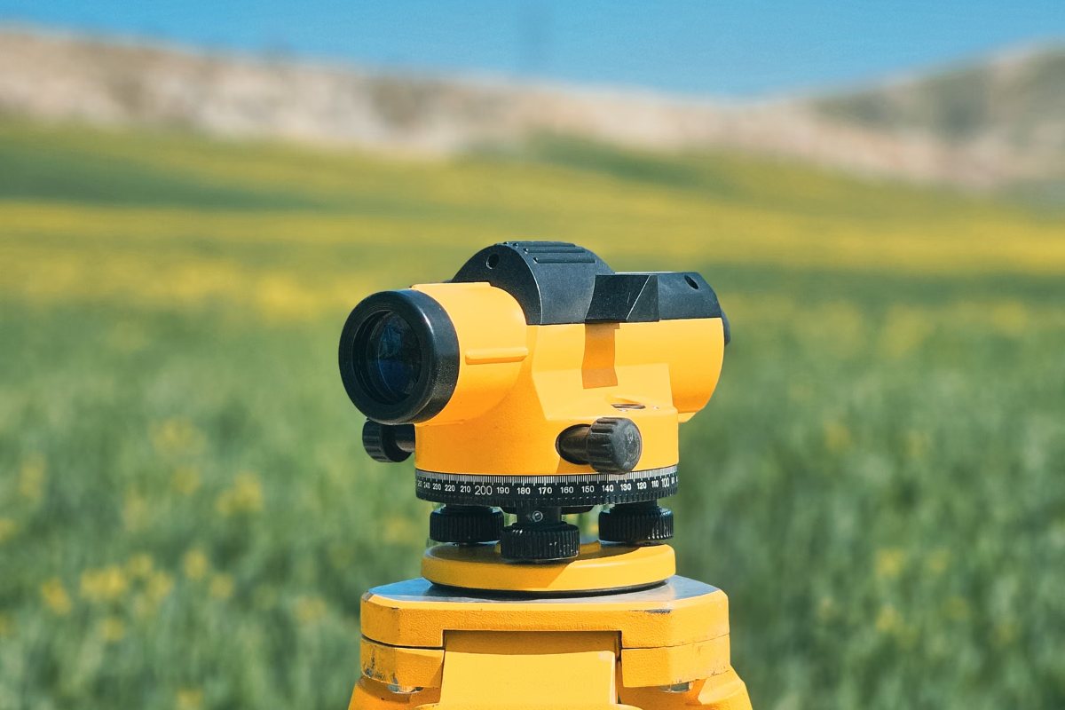 Surveying equipment set up in an open field to measure property boundaries