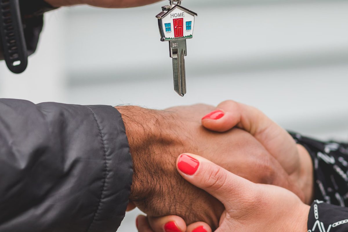 House-shaped key handed over to seal a real estate closing